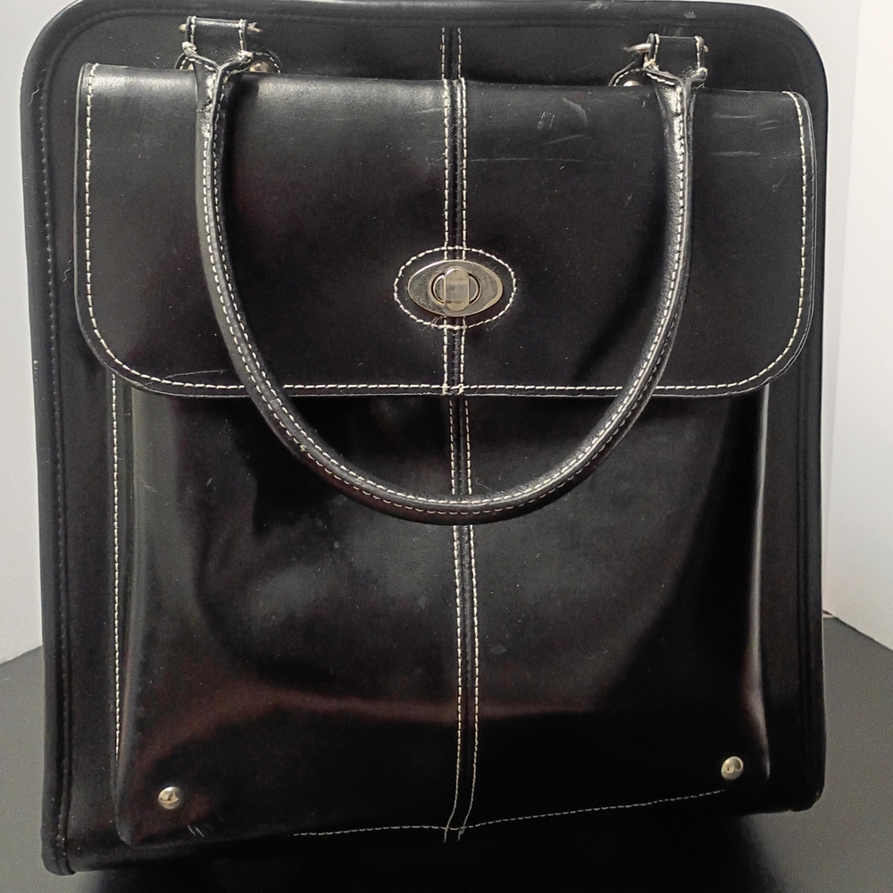Wilsons Leather Black Travel Bag With Zippered Pull Out Handle And Wheels